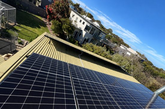 Jinko tiger neo panels across the tin roof of jeneane's anglesea home, coastal homes and bush behind