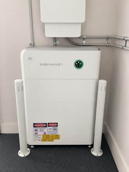 Sigenergy sigenstor inverter and battery, bollard-protected on cement sheeting in the garage of daryl's balwyn north home