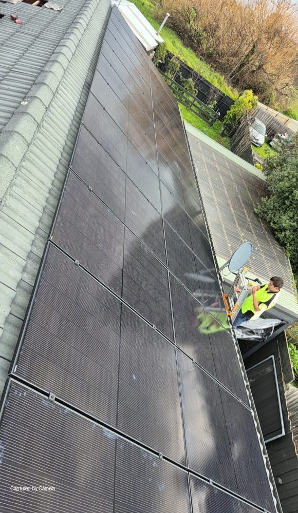 Powerband installer on the tile roof of daniel's baxter home, satellite dish visible nearby