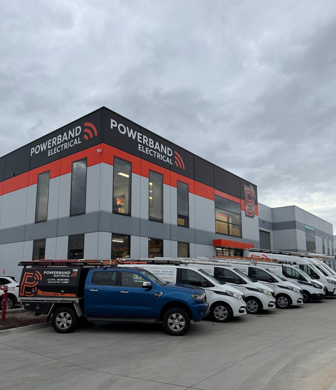 Powerband electrical's somerville office with the fleet of vans and utes lined up out front