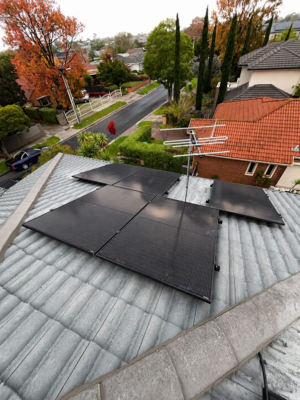 Aerial view of jinko solar tiger neo iii panels across the tile roof of sharon's bentleigh east home