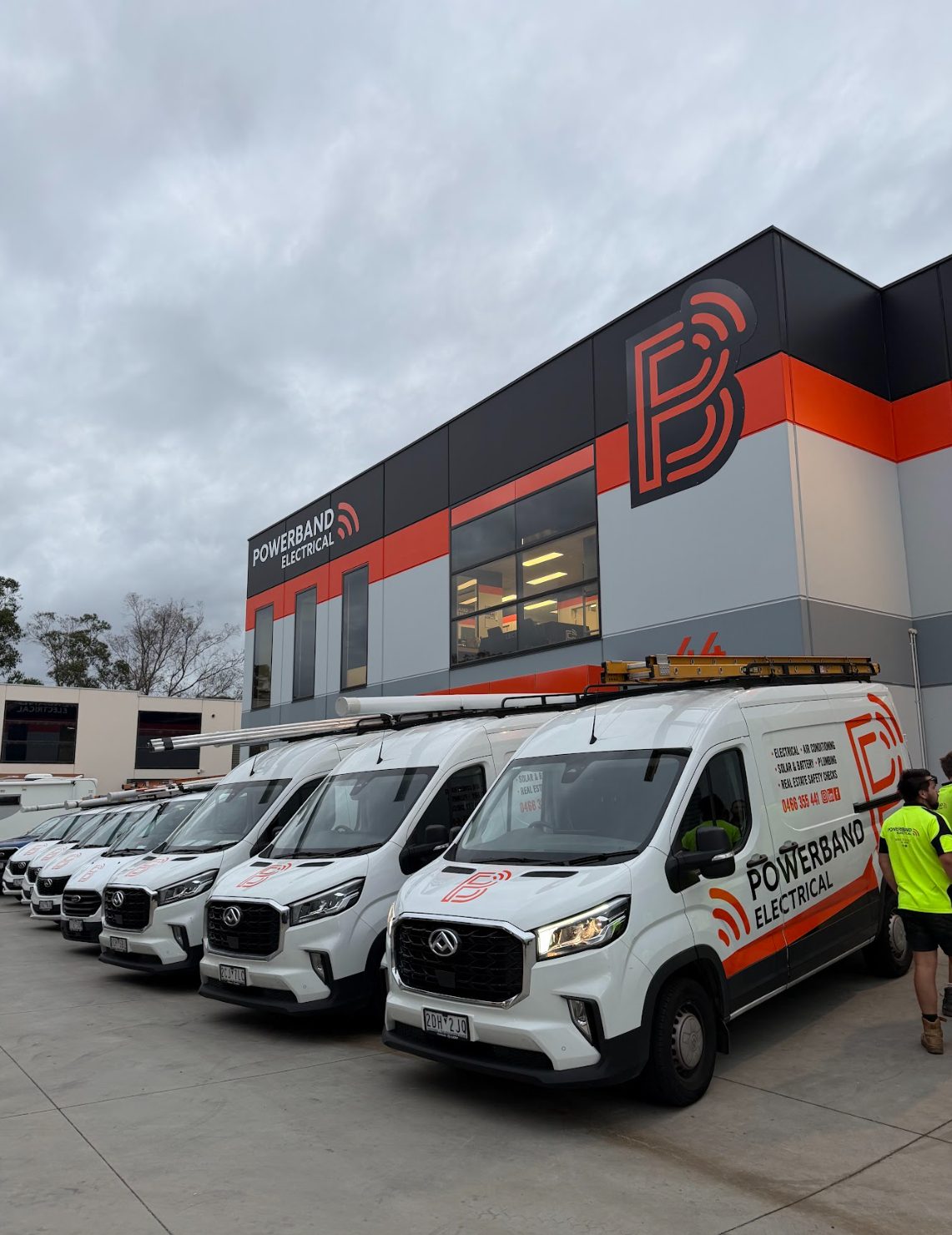 Powerband electrical fleet vehicles outside the head office