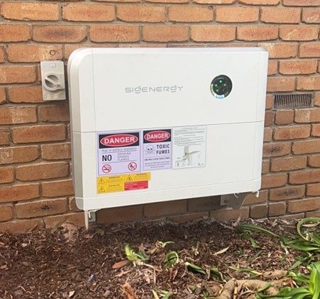 Sigenergy sigen hybrid inverter mounted against the exterior brick wall of cristiane's berwick home