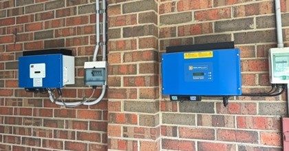 Pre-existing inverter units mounted on the brick wall of steven's bittern home