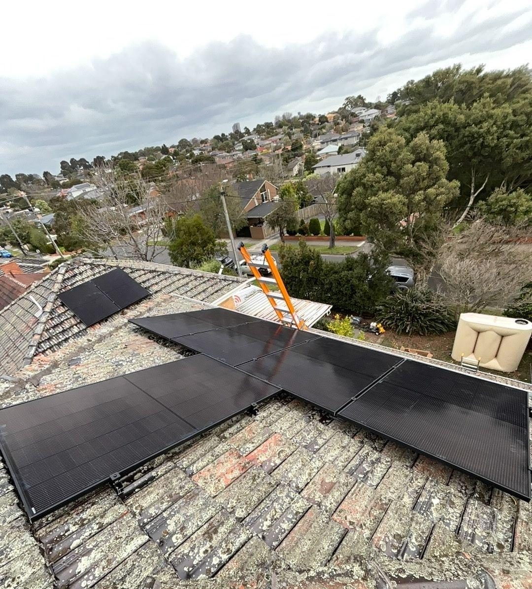 Twenty-four jinko panels spread across several roof planes of a double-storey blackburn north home, looking south-west over the suburb