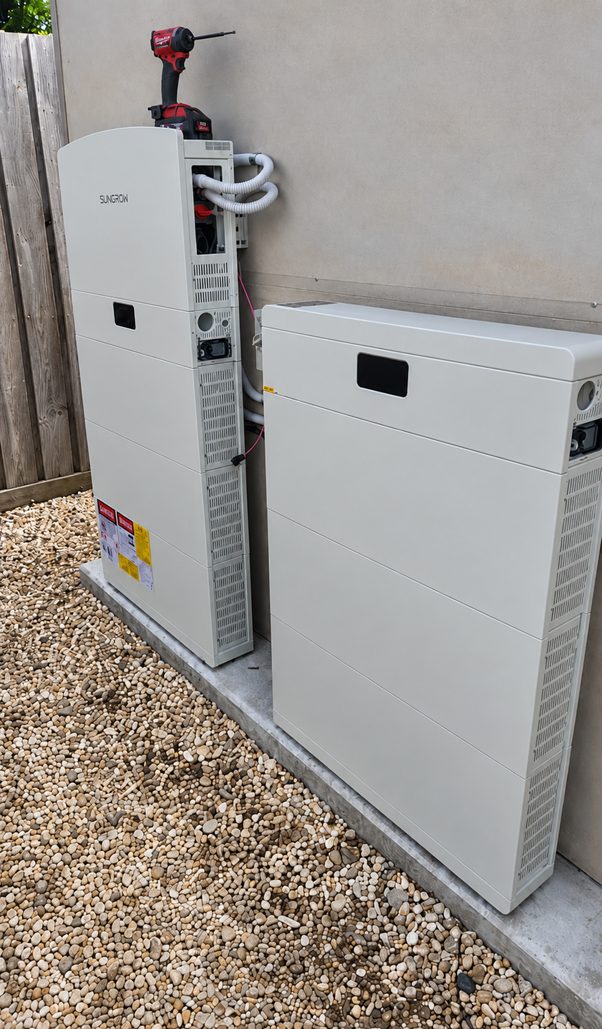 Battery and inverter units installed on a concrete pad against the exterior wall of duncan's blairgowrie home
