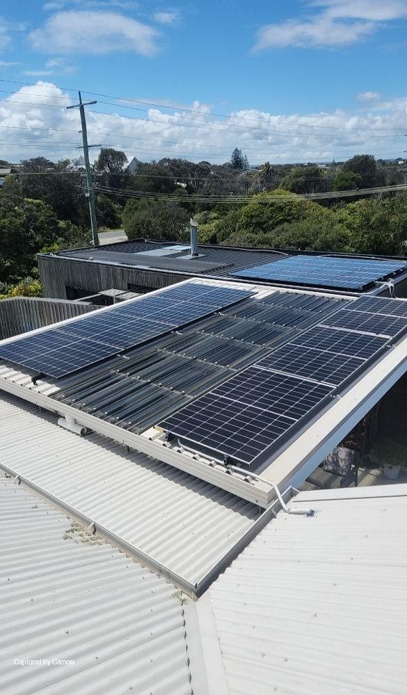 Aerial view of jinko solar tiger neo panels across the tin roof of duncan's blairgowrie home, tile roof array behind
