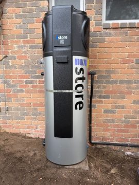 Istore 270l heat pump hot water unit against the brick wall