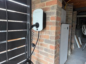 Sigen 22 kw ev charger mounted on the brick pillar at the garage door