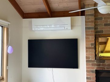 Mitsubishi electric indoor split unit above the living room tv