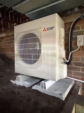 Outdoor compressor unit on besser blocks under the house
