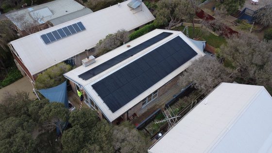 Aerial view of 36 all-black jinko tiger neo iii panels across the north and rear roof pitches of wayne's double-storey blairgowrie home