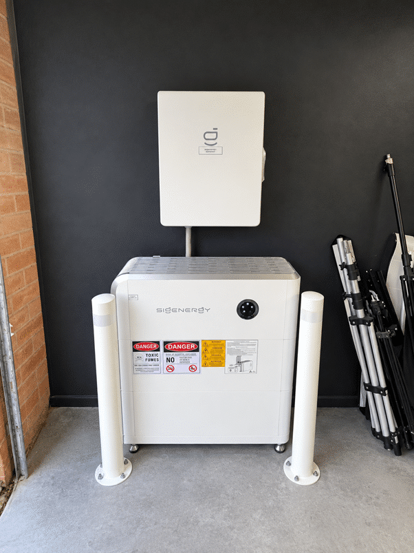 Sigenergy inverter and battery behind protective bollards at a berwick home