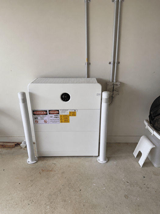 Goodwe battery modules behind bollards in the garage of a botanic ridge home