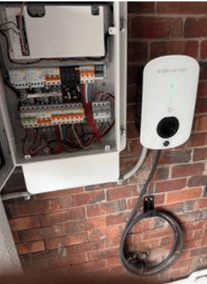 Switchboard and ev charger mounted on a garage wall in camberwell, installed by powerband electrical