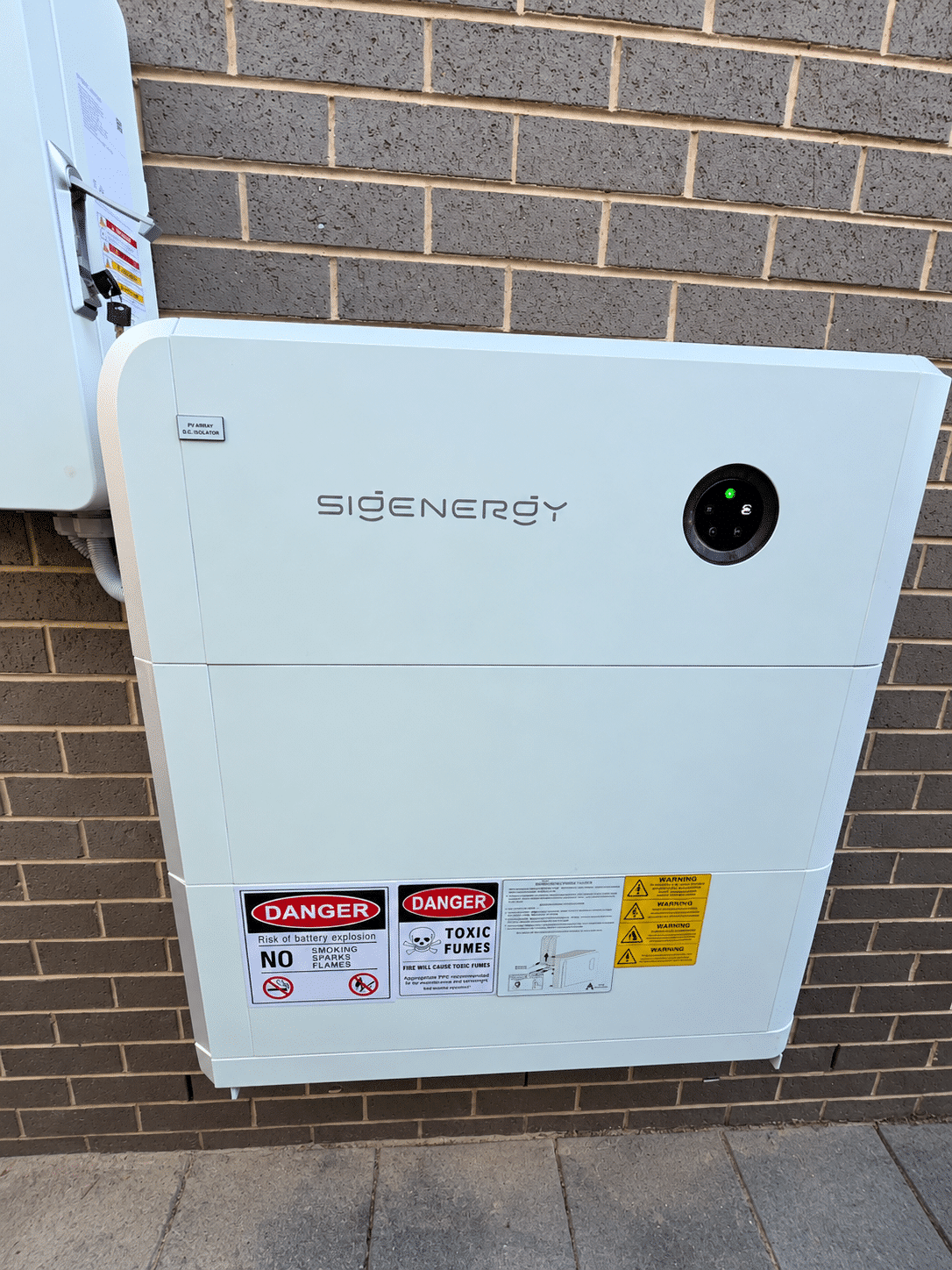 Sigenergy hybrid inverter and sigenstor battery on the brick wall of a chelsea home