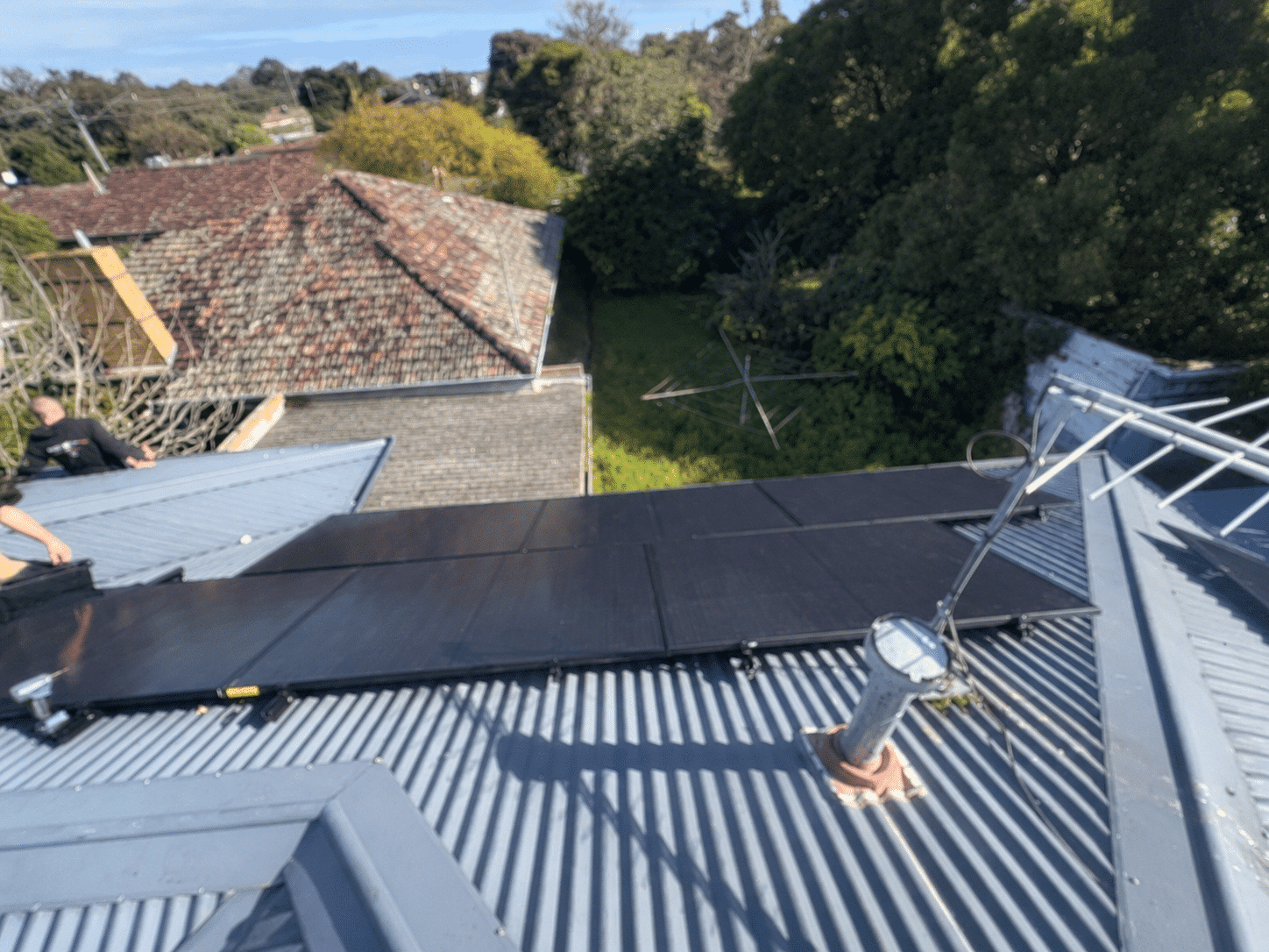 Jinko solar panels on the tin roof of a double-storey home in chelsea heights