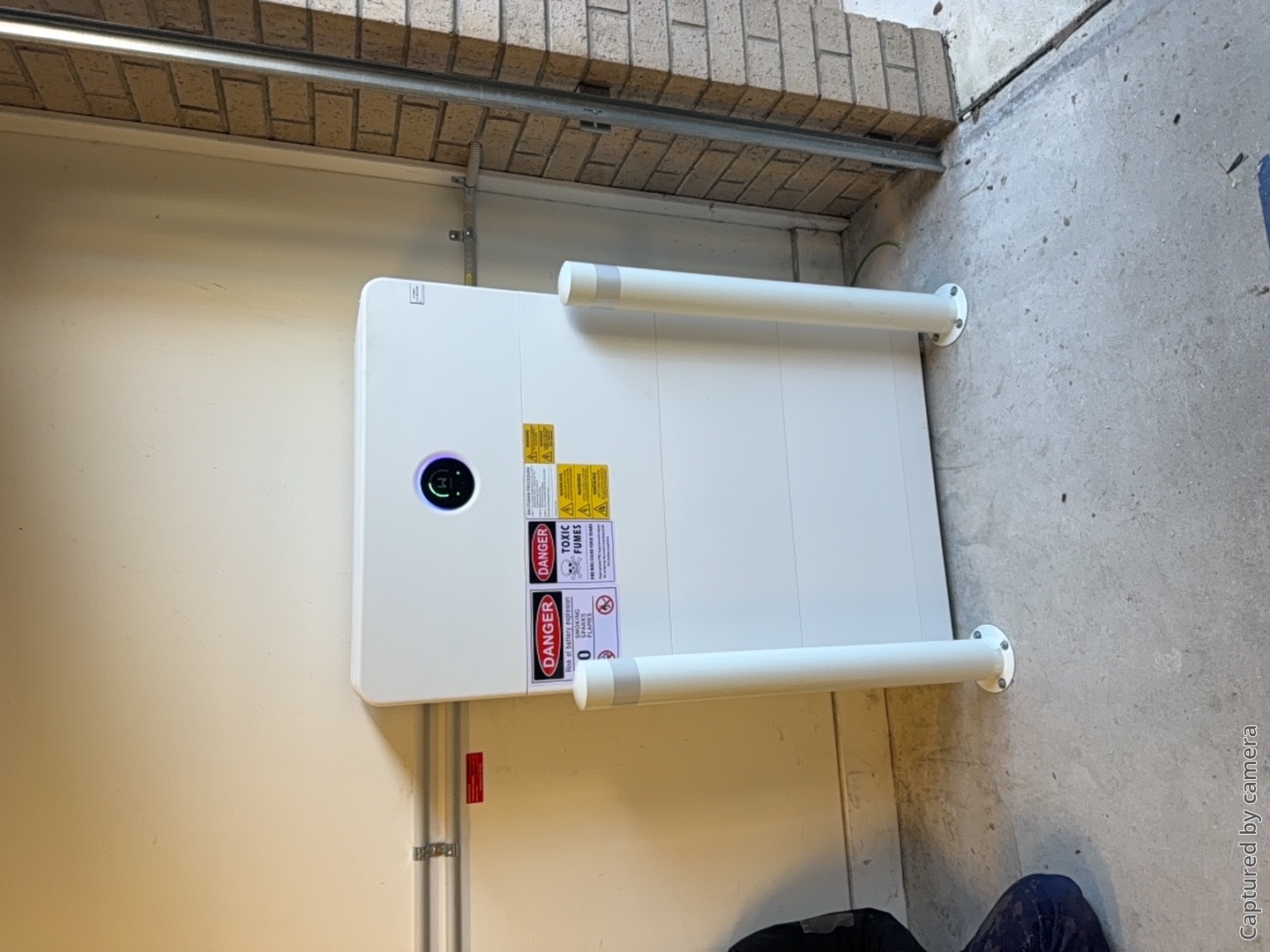 Battery storage protected by bollards in the garage of a chelsea heights home