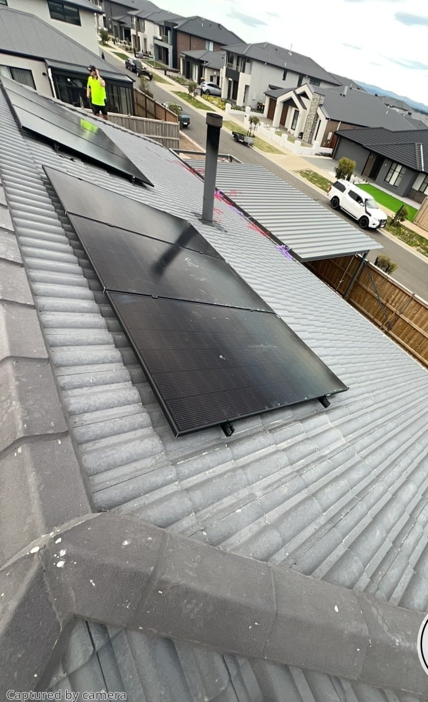 Jinko solar panels on a new-build home in clyde north, seen from above with the street below