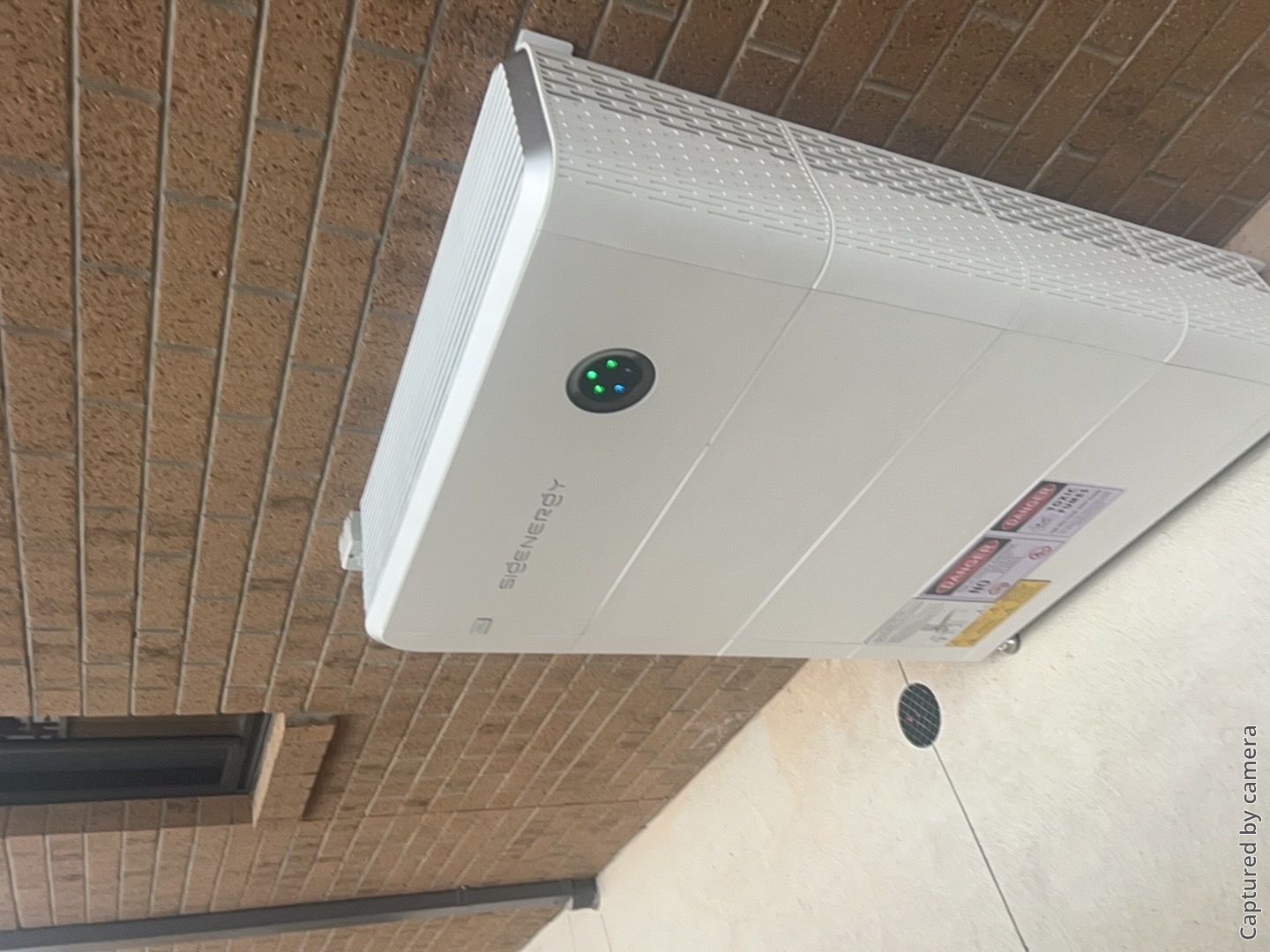 Sigenergy sigenstor battery mounted on the brick wall of a clyde north home by powerband electrical
