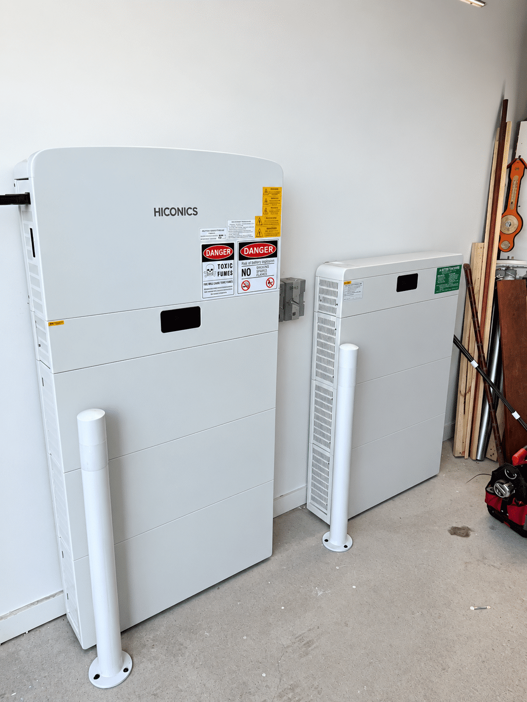 Inverter and six battery modules against the garage wall of a new clyde north home