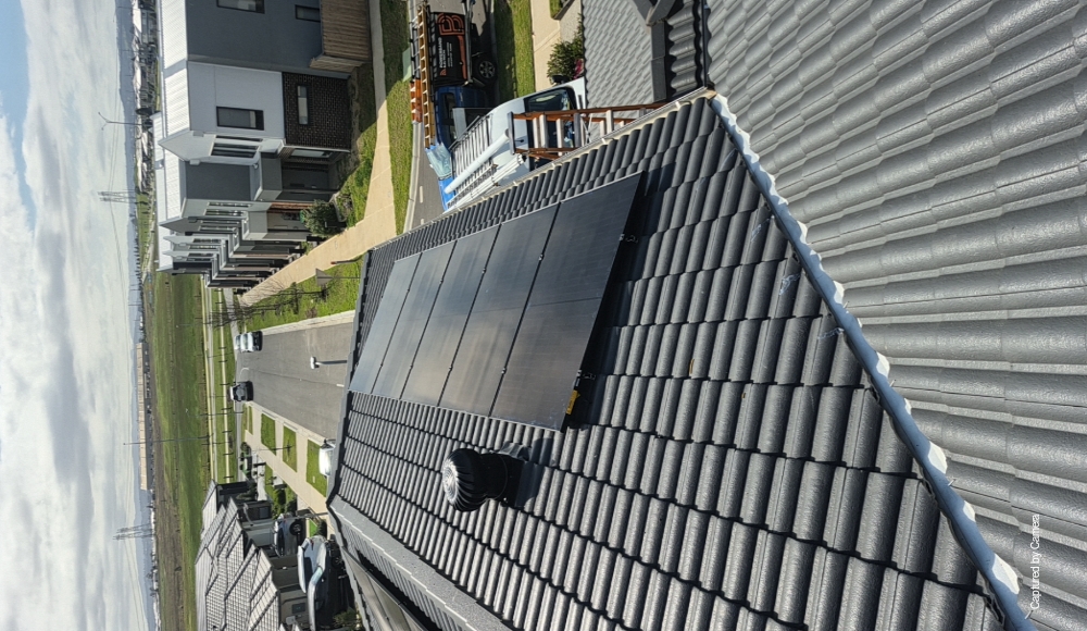 Solar panels on the roof of a clyde north estate home with a three-phase ev charger