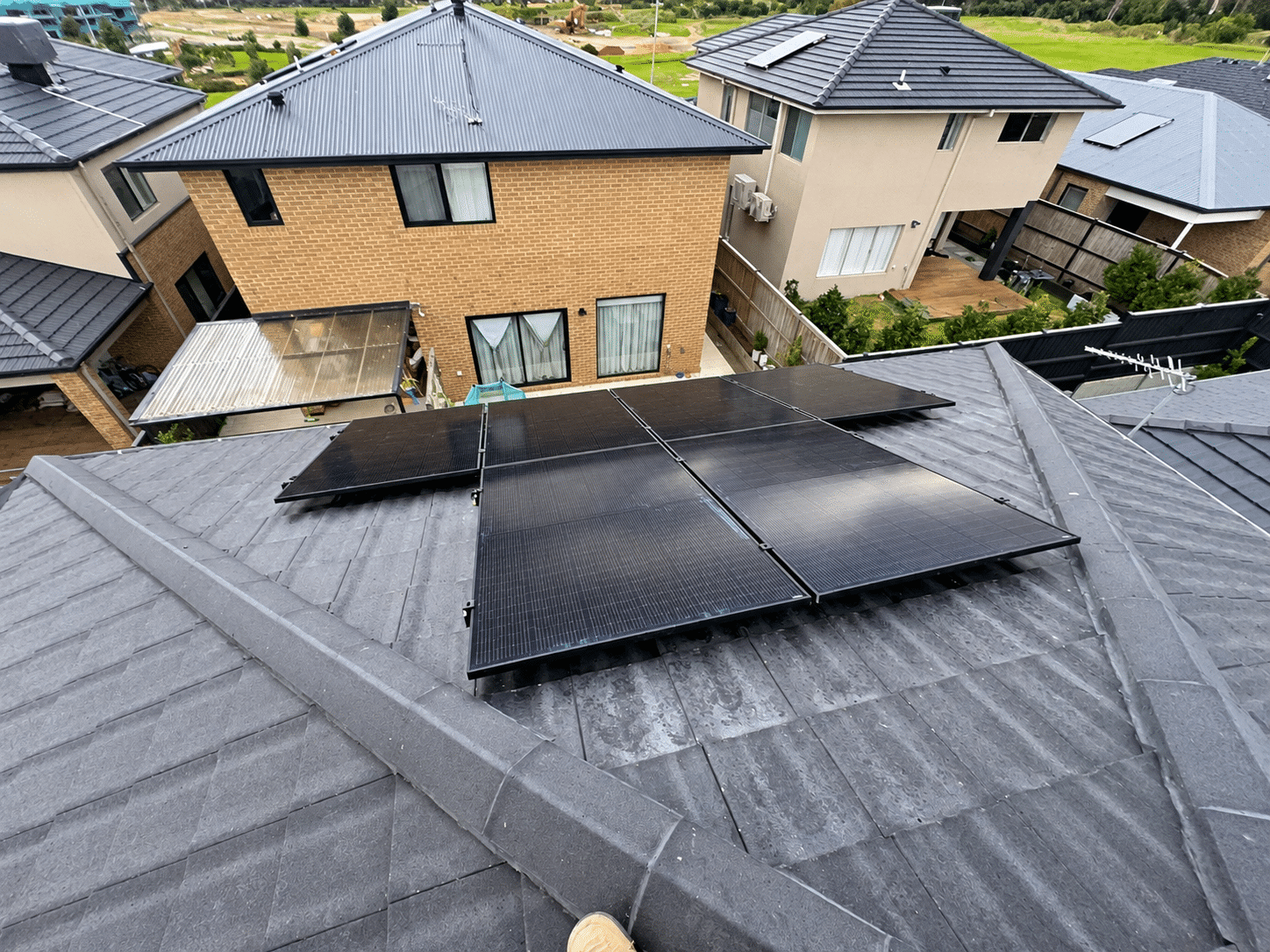 Aerial view of jinko solar panels on the tile roof of a double-storey cranbourne south home