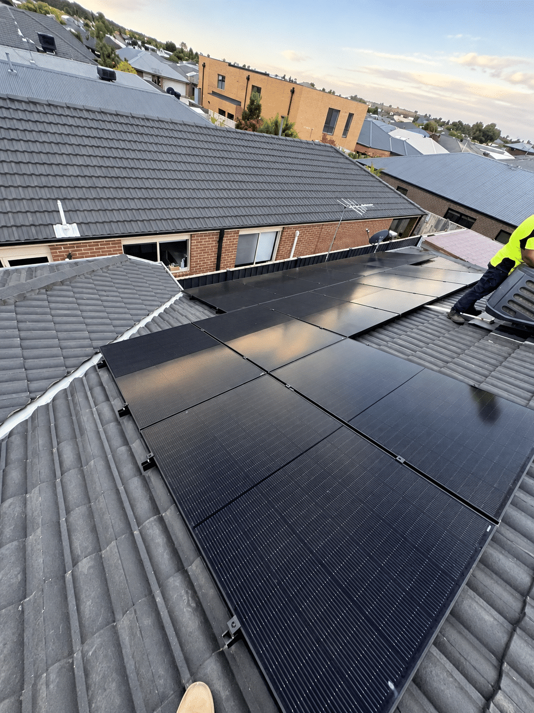 Powerband installer fitting jinko solar panels on a cranbourne west roof