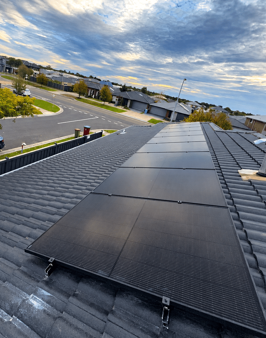Jinko solar panels running up a tile roof in cranbourne west, with the street below