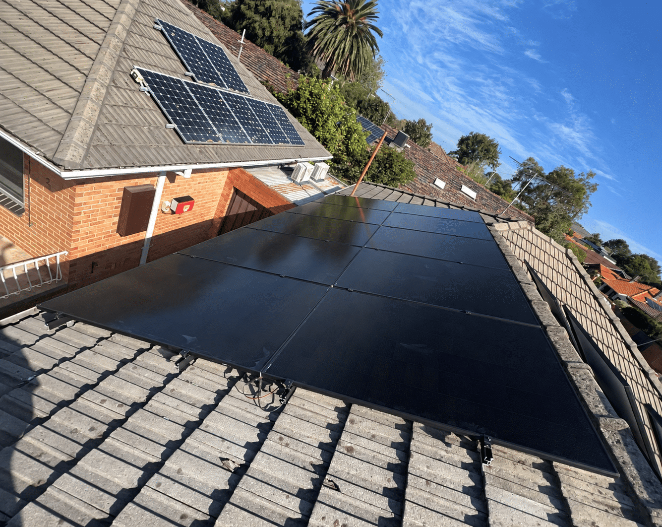 Aerial view of aiko solar panels on the narrow terracotta roof of an elsternwick terrace