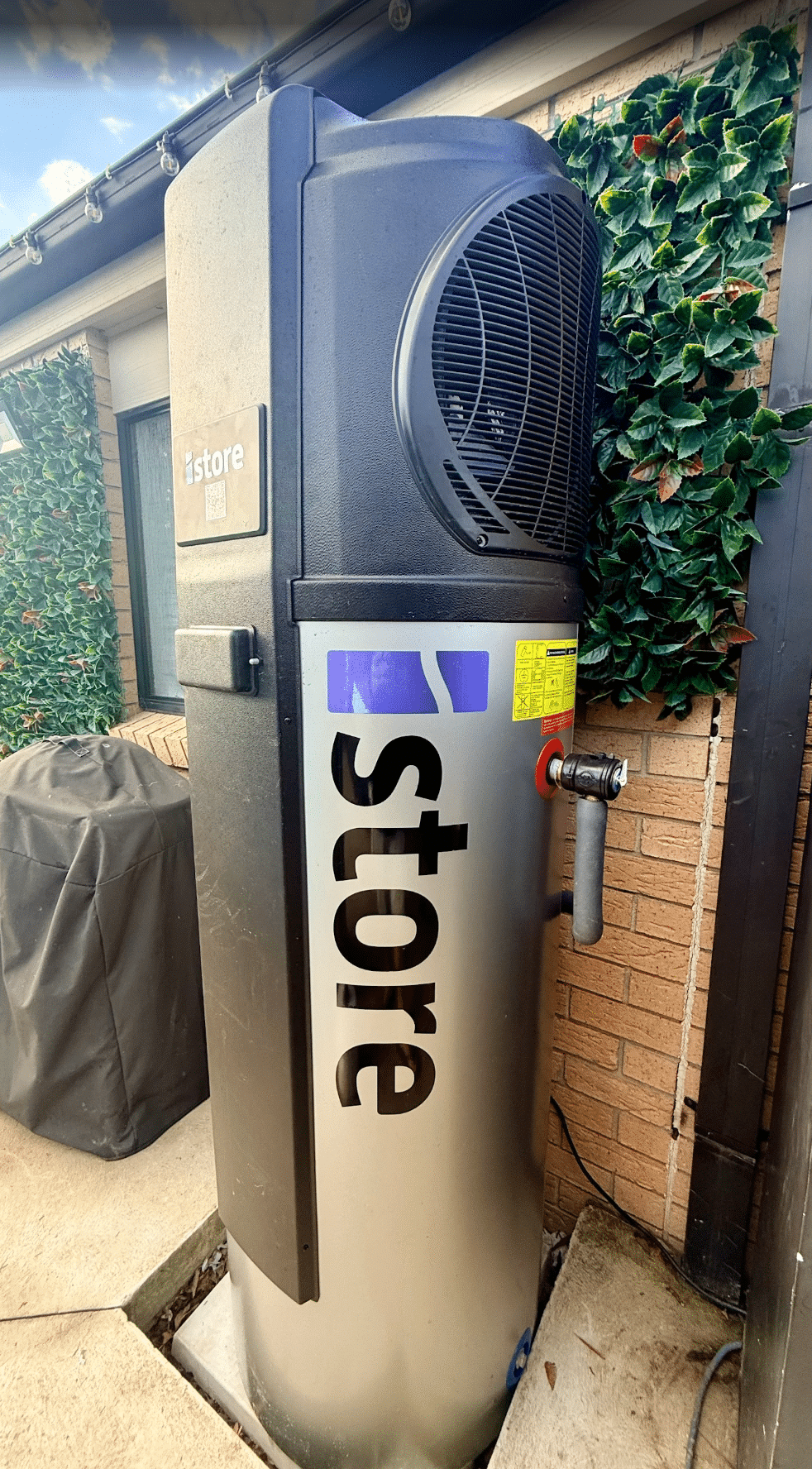 Istore heat pump hot water unit installed outside a home in hastings by powerband electrical
