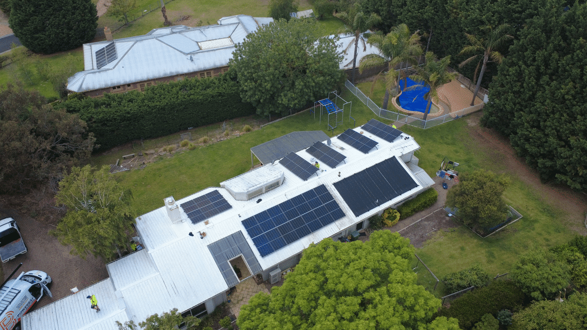 Aerial view of a full roof of solar panels on a mount eliza home with a pool