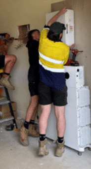 Powerband installers fitting sigenstor battery modules inside a mount martha home
