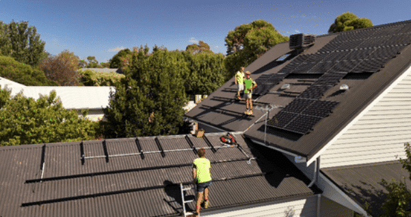 Powerband installers fitting jinko solar panels on a mount martha roof
