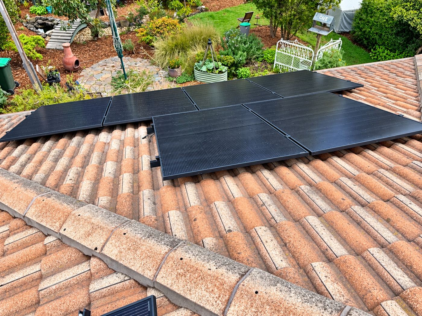 Aerial view of solar panels on a tile roof above a garden in mount martha