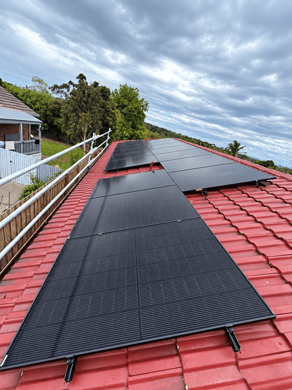 Jinko solar panels on the tile roof of a somerville home, seen from above