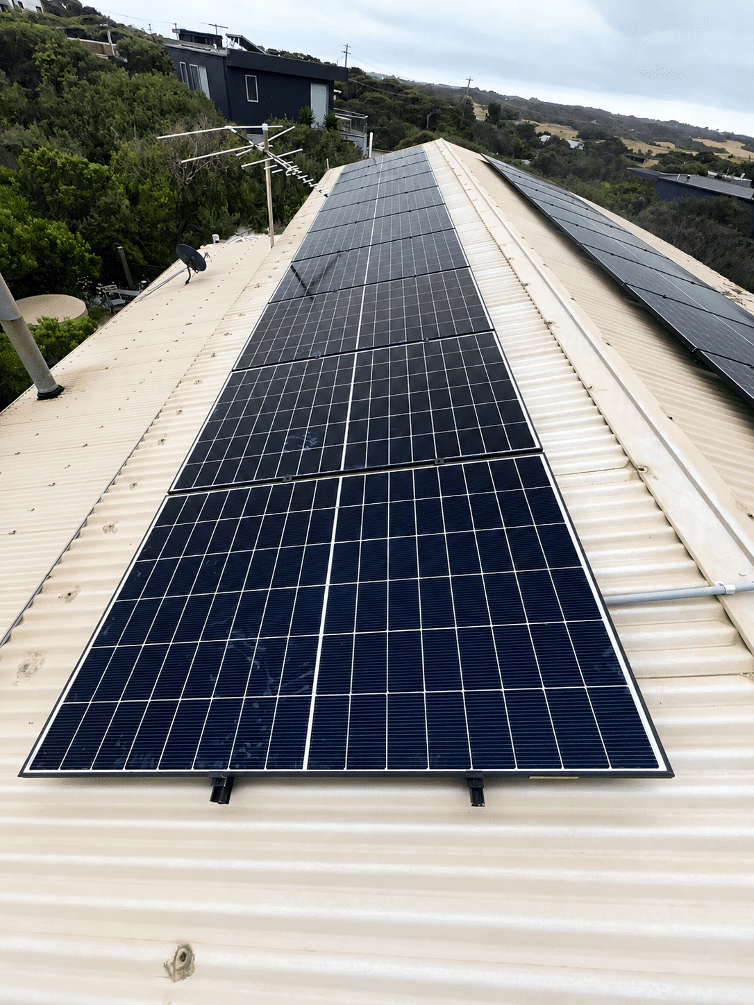 Twenty jinko solar panels across a tin roof in st andrews beach, replacing an older corroded system