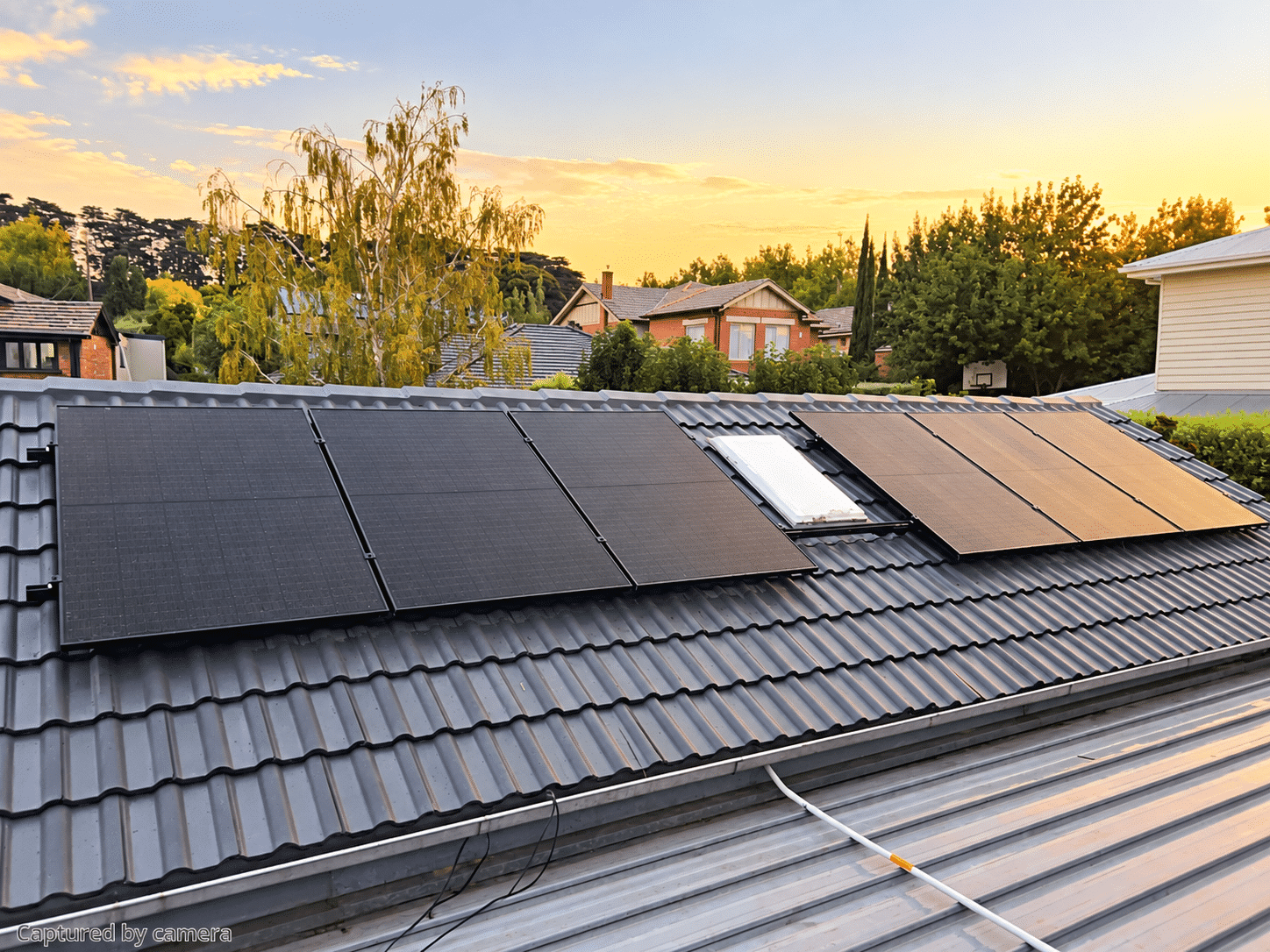 All-black solar panels on a second roof plane of a surrey hills home