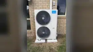 Blogs 12 Ducted reverse cycle heating and cooling outdoor unit installed beside a brick home