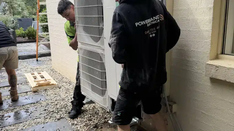 Stay Comfortable: Why Regular Hvac Maintenance Matters 2 Technicians carrying out hvac maintenance on an outdoor unit