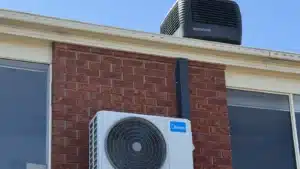 Blogs 7 Reverse cycle air conditioner outdoor unit below a rooftop evaporative cooler on a melbourne home
