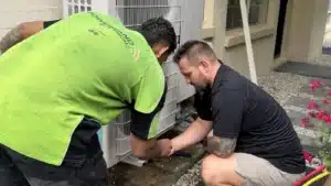 Blogs 8 Powerband technicians working on a ducted air conditioner outdoor unit