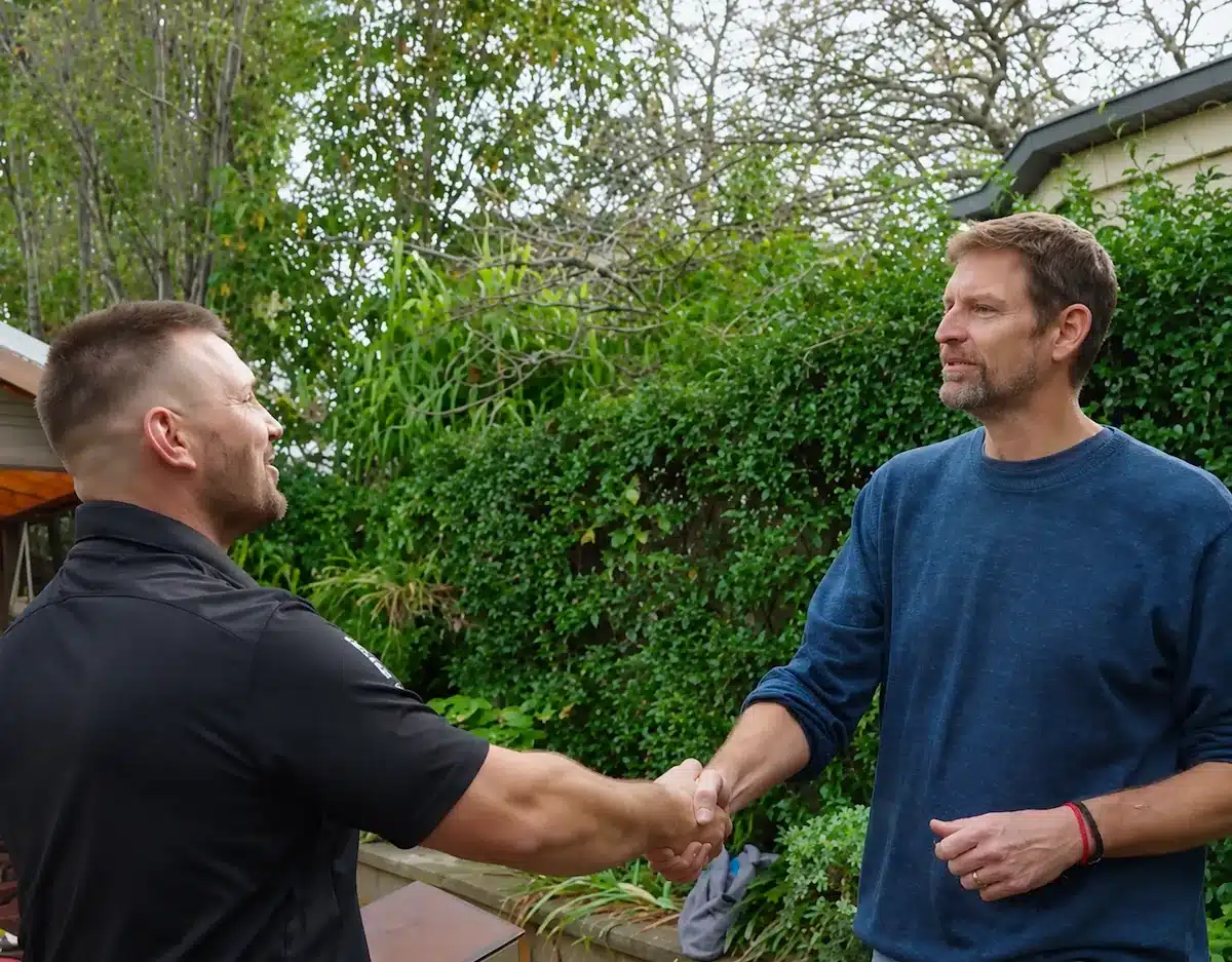 Home 1 Tim davies, director of powerband electrical, shaking hands with a customer at their melbourne home